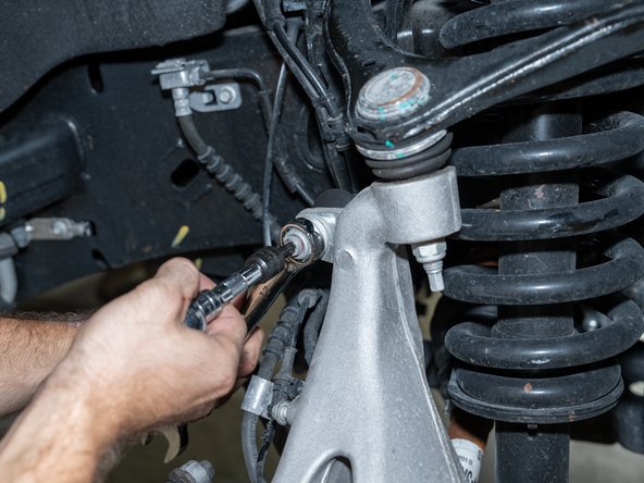 Using a 21mm wrench and T45 Torx driver, disconnect the sway bar link from the knuckle.