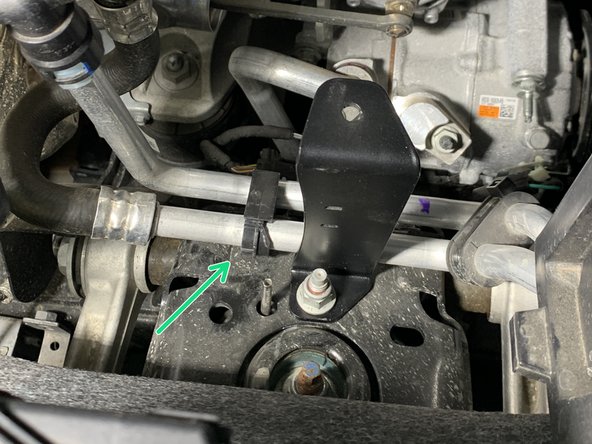 Reinstall the left coolant line clip onto the coolant lines and insert the christmas tree clip end on the bottom back into the hole in the shock tower where it was removed from.