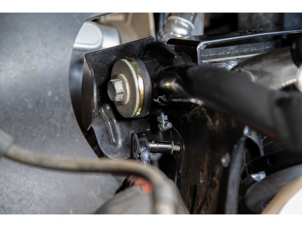 Grease the zerk fittings until grease is visibly coming out of the bushings and then tighten the pivot bolt.