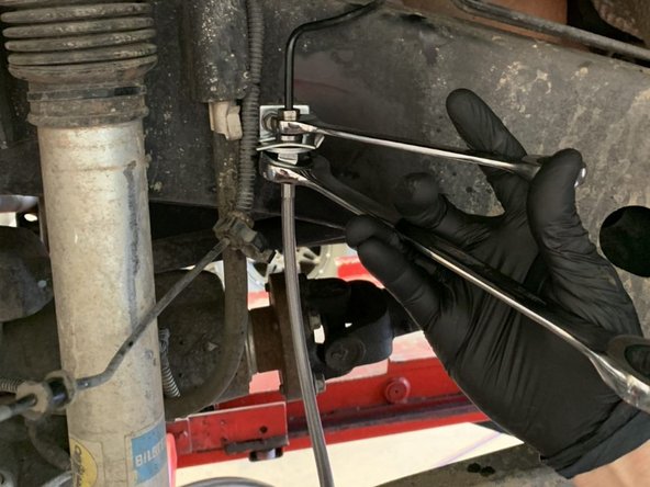 Thread the factory hard line nut into the Grimm OffRoad brake line.