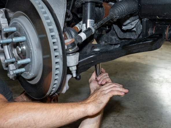 Remove the nuts from the upper strut mounting studs with an 18mm socket/wrench.