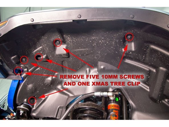 Re-install the five screws using a 10mm socket/wrench and press the push pin back into place.