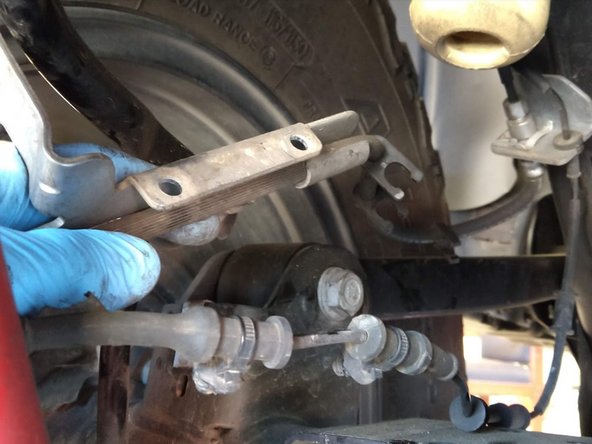 Remove the two push in studs that secure the wheel speed sensor wire to the brake line retaining bracket.