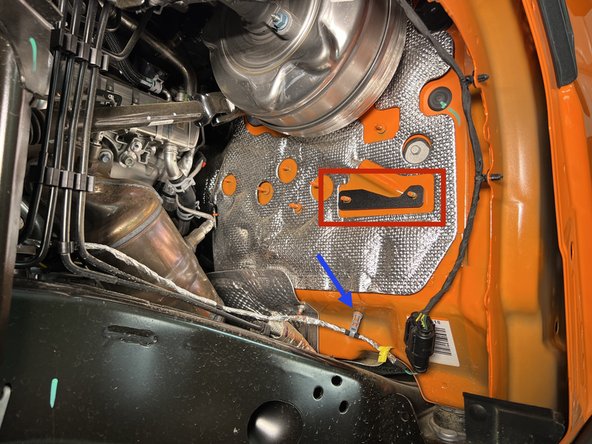 Pull the wire harness retainer off the stud.