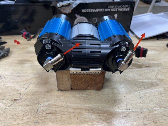 Install the two 1/4” NPT x 1/2” barb 90° fittings into the inlet ports on the ARB Twin Compressor. Use thread sealant on the NPT threads and clock the barb fittings as shown in the picture.