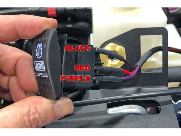Plug the wires into the back of the ARB compressor switch. The BLACK wire goes to the top terminal, the RED wire goes to the center terminal and the PURPLE wire goes to the lower terminal.