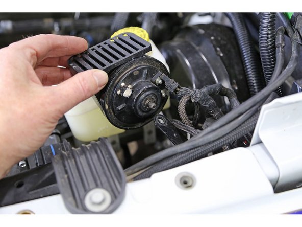 Remove the horn from it’s mount. Use a 10mm wrench to remove the nut.