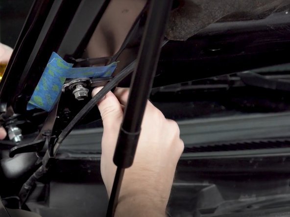 There is a left and right hood hinge light bracket. Make sure you have the correct bracket for the side you are installing. The brackets install from the center of the vehicle out, with the slots sliding over the hood bolts as shown.