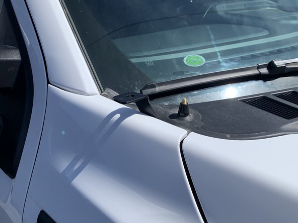 Align the bracket to the edge of the fender and tighten the cowl fender bolt with a 10mm socket.