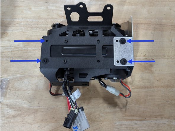 With the mounting holes of the ARB Twin compressor facing up, set the Grimm OffRoad Compressor Bracket onto the Compressor, sliding the wiring harness though the large hole in the bracket as shown.