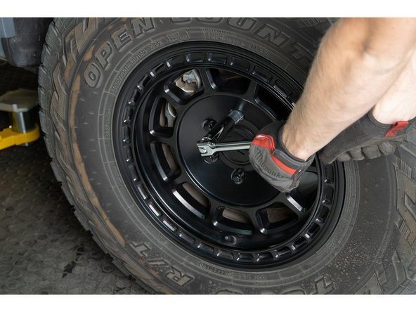 Re-install wheels and put vehicle back on the ground.