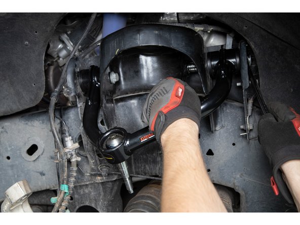 Re-install the factory upper control arm hardware, keeping hardware hand tight for now.