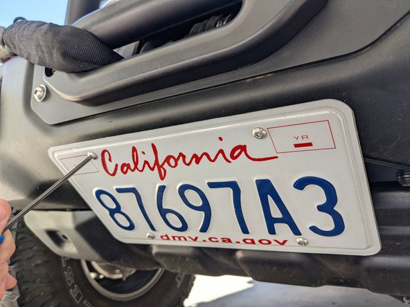 Place license plate over mounting bracket and install with the provided mounting hardware.