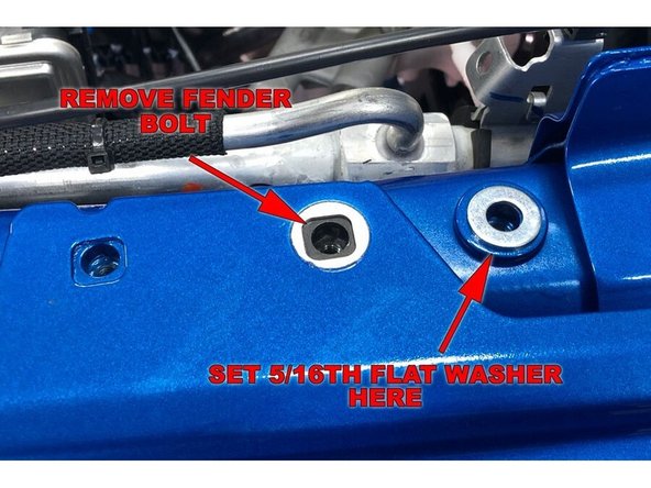 Remove the fender bolt shown with a 10mm wrench/socket.