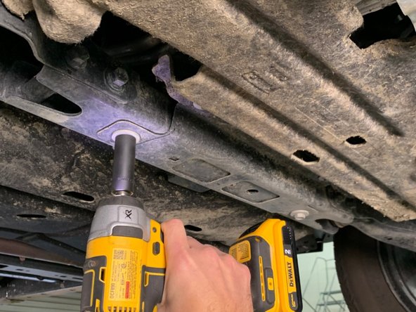 Using a 15mm wrench/socket, remove the forward two bolts.