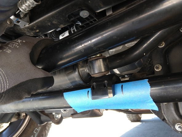 Place a piece of painters tape on the tie rod, and make a mark at the approximate center of the damper mounting hole with the damper fully extended and the steering fully locked.