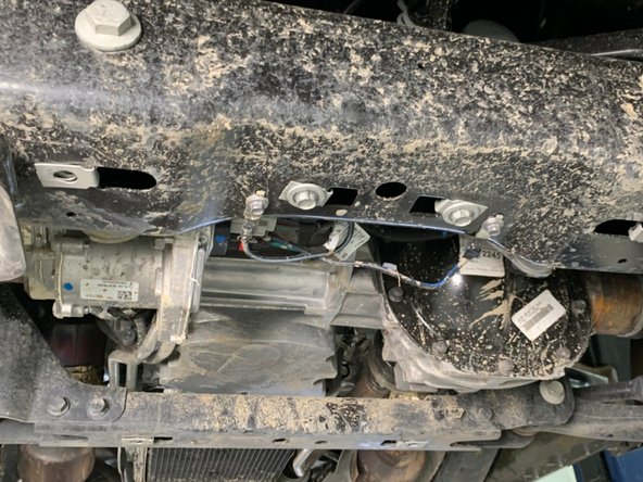 Re-install the hardware after removing the skid plate.