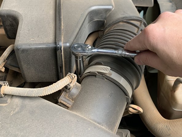 Loosen the hose clamp securing the intake tube to the airbox lid with a 10mm socket/wrench. Remove the airbox lid and filter and place to the side.