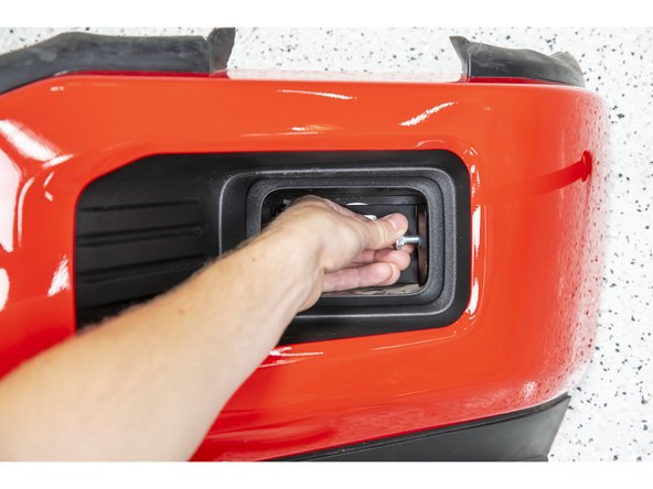 Insert two of the 5/16" carriage bolts through the side holes in the Grimm OffRoad fog light bracket and through the retaining clips in the bumper.