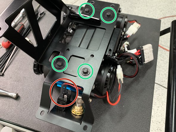 With the mounting holes of the ARB Twin compressor facing up, set the Grimm OffRoad Main Bracket onto the Compressor oriented as shown.