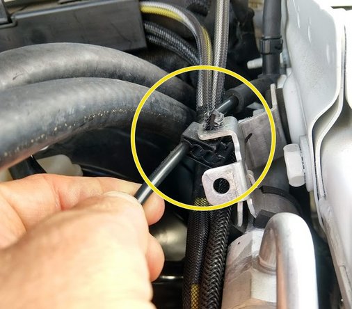 The clip on the fender holding the washer line needs to be flipped upsidedown, to the other side of the bracket as shown.