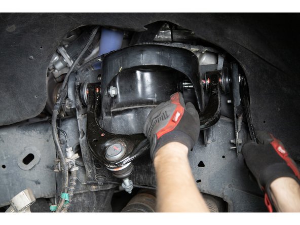 Remove the stock upper control arms.