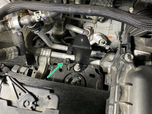 Reinstall the left coolant line clip onto the coolant lines and insert the christmas tree clip end on the bottom back into the hole in the shock tower where it was removed from.
