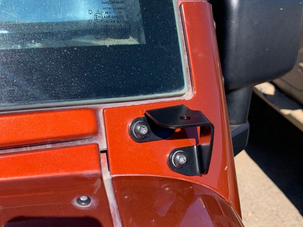 Place the light mounts over the windshield frame holes and re-install hardware.