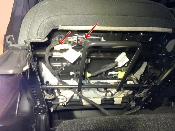 Release red tab and remove both seat wiring harnesses from seat. Remove seat from vehicle.