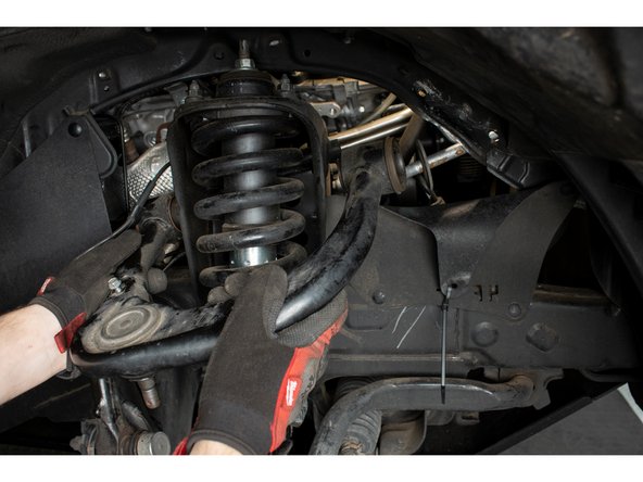 With the upper control arm pivot bolt out, remove the stock upper control arm.