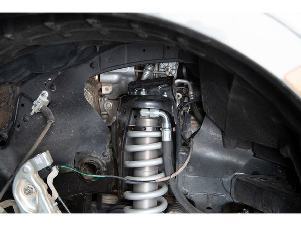 Remove the upper control arm assembly from the vehicle.