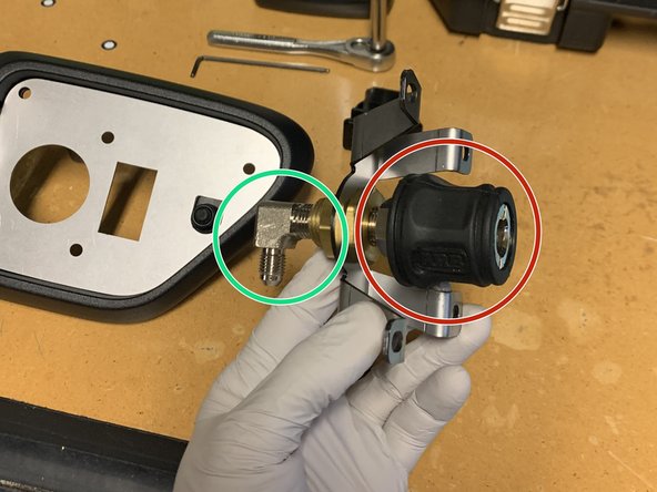 Install the 1/4” NPT x JIC4 90° fitting into the back of the bulkhead fitting as shown using a 9/16" socket/wrench. Make sure the fitting is pointed down. Use thread sealant on the NPT threads.