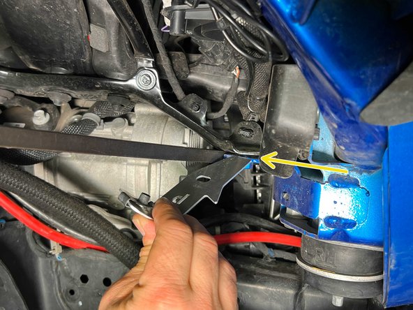 The fender mounting bracket should be slid between the body bracket and the inner support bracket. A pry bar can be used to help make a gap for the mounting bracket.