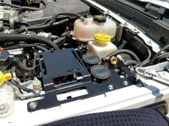 Push hoses from compressor onto the barb fittings on the back side of the air filters.