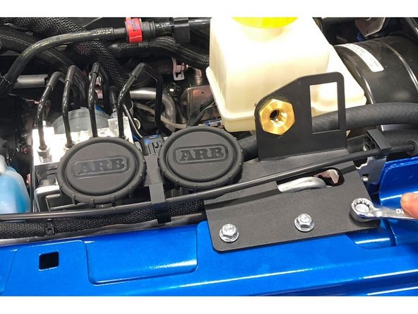 Place the provided 5/16&quot; flat washer over the hole to the right of the fender bolt removed.