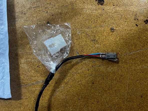On the ARB power harness coming from the compressor, there should be a white connector housing in a bag attached to some male spade connectors. We are going to use only the red wire from the ARB power harness. The white connector and other wires are not needed.