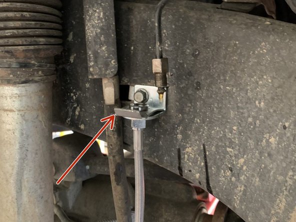 Insert the Grimm OffRoad brake line up through the newly installed brake line bracket on the frame and secure with the provided clip.