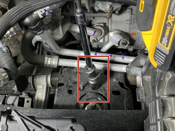 Using a 15mm socket, remove the upper shock tower mounting nut and install the support bracket as shown using factory flange nut.