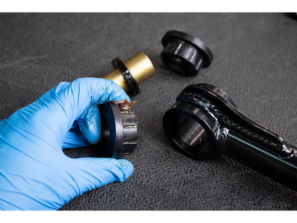 Apply grease to the inside of the upper control arm pivot tubes and insert the Pivot Sleeves with Load Rings into the arms.