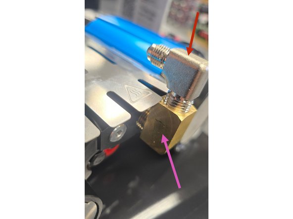 The brass street elbow needs to be installed before the silver 1/4” NPT x JIC4 90° elbow can be installed due to clearance. It is easier with the heat shield removed, but can be done with the heat shield in place by carefully moving the heat shield out of the way for each turn of the fitting.