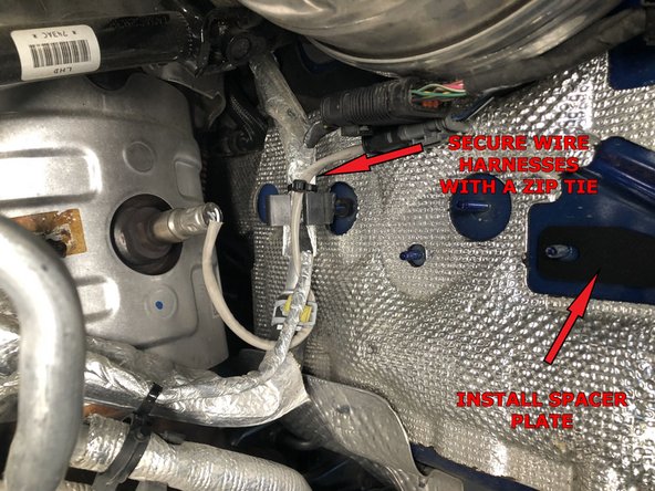 Remove the two nuts holding the plug bracket with a 10mm socket or wrench.  Save the nuts, as they will be used later. Discard the plug mounting bracket.