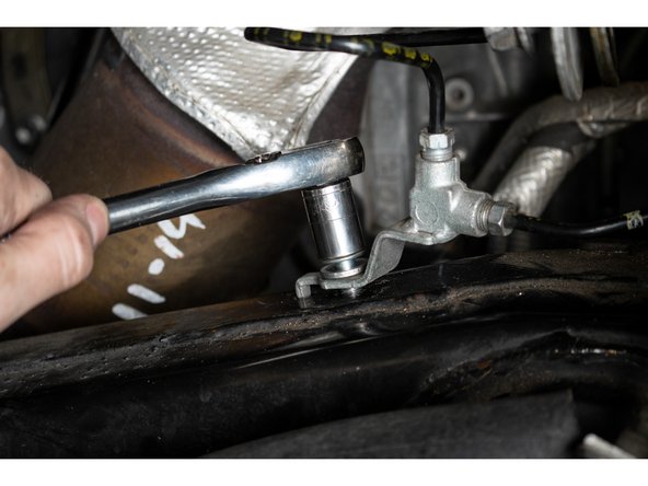 Re-install the long upper control arm pivot bolt from the opposite side, rear of the vehicle towards the front, with one of the supplied washers on each side of each upper control arm bushing.