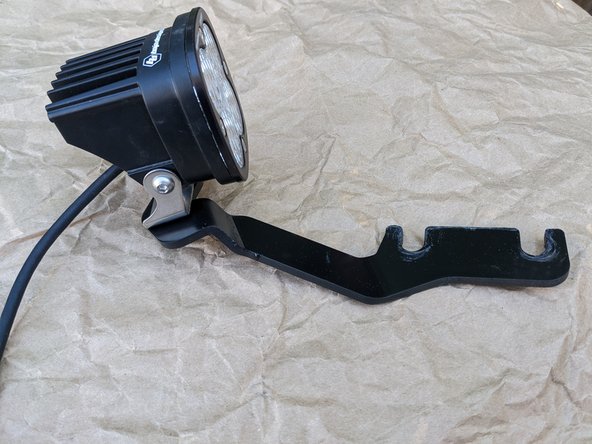 It is easiest to install the lights on the brackets before installing the brackets on the vehicle.