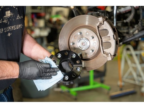 Clean the wheel spacer mounting surface with a clean shop towel.