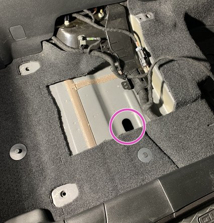 Locate the grommet in the floor and remove. This is where the ARB power harness will eventually be routed.