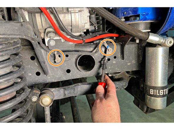 With your trim removal tool, remove the wiring harness clips from the frame and secure the harness above the frame.
