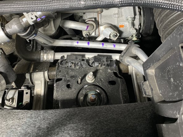 Use a flat head screw driver to open the coolant line clips as shown.