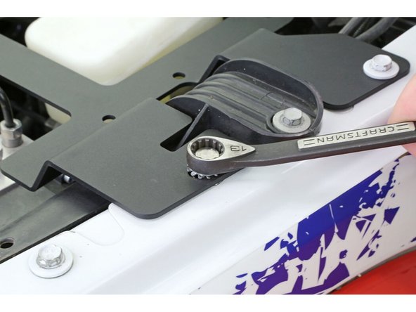 Set the compressor mounting plate onto the fender and the compressor mount gusset.