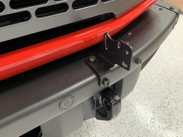 Install the light bar mounting brackets with the screws removed in the last step, but leave loose for now.