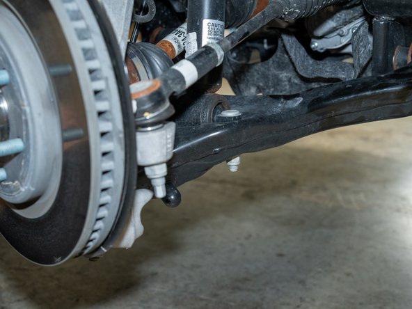 Remove the nuts from the lower strut mounting studs with an 18mm socket/wrench.